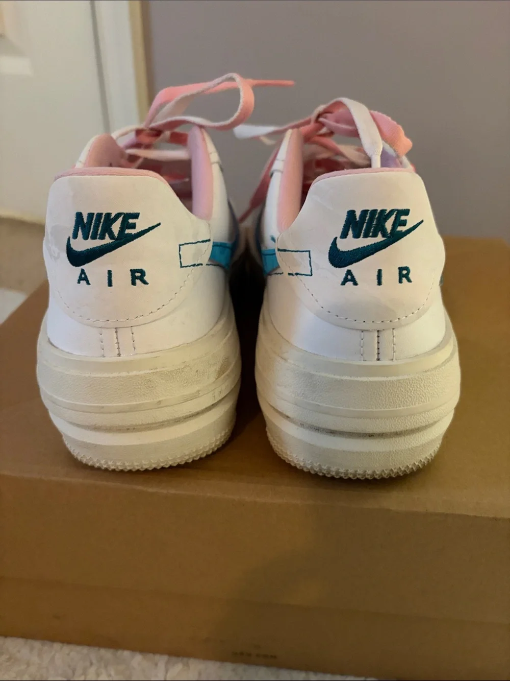 Nike Woman’s White Sneakers with Blue Swoosh and Pink Laces